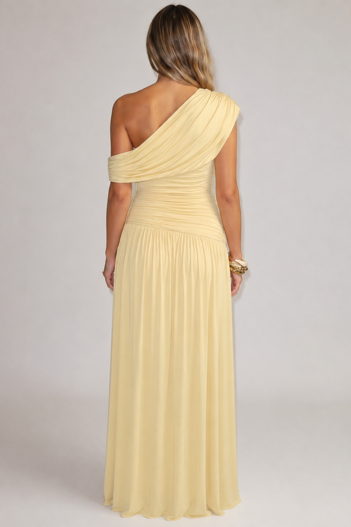 Back view of the yellow maternity maxi dress with a one-shoulder line, ruched bodice and long gathered skirt.