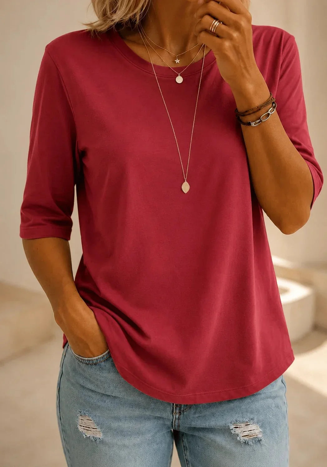Woman wearing a red round neck tee with half sleeves