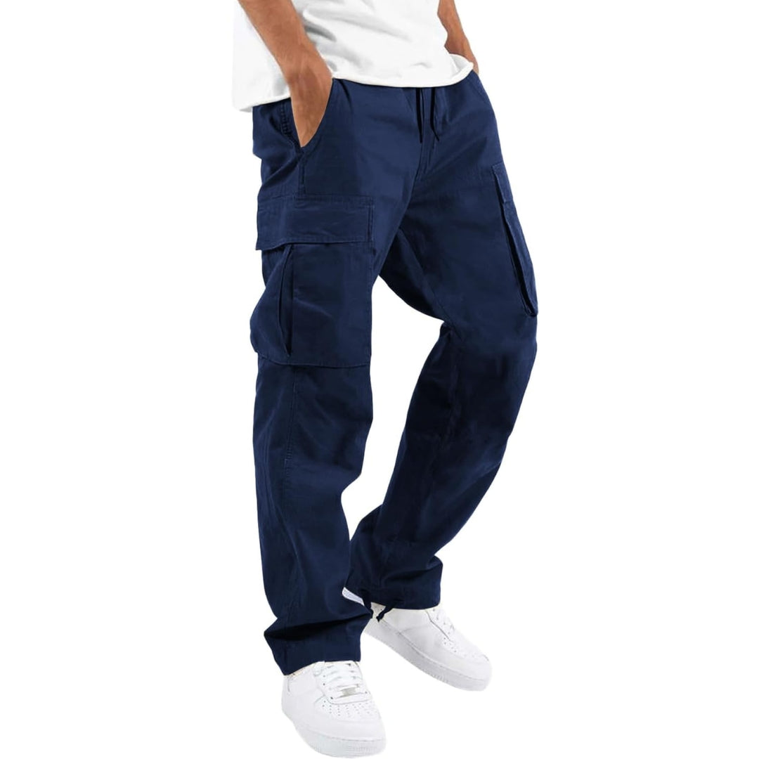 Model wearing navy blue cargo pants with white tee and white sneakers, hand in pocket, angled side view. 6