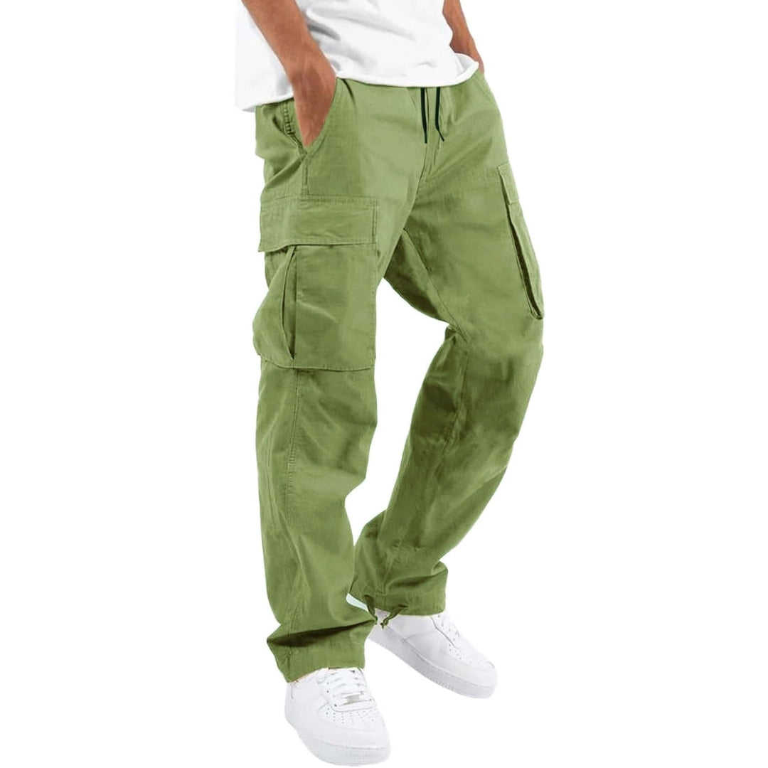 Model wearing light green cargo pants with white tee and white sneakers, hand in pocket, angled side view. 9
