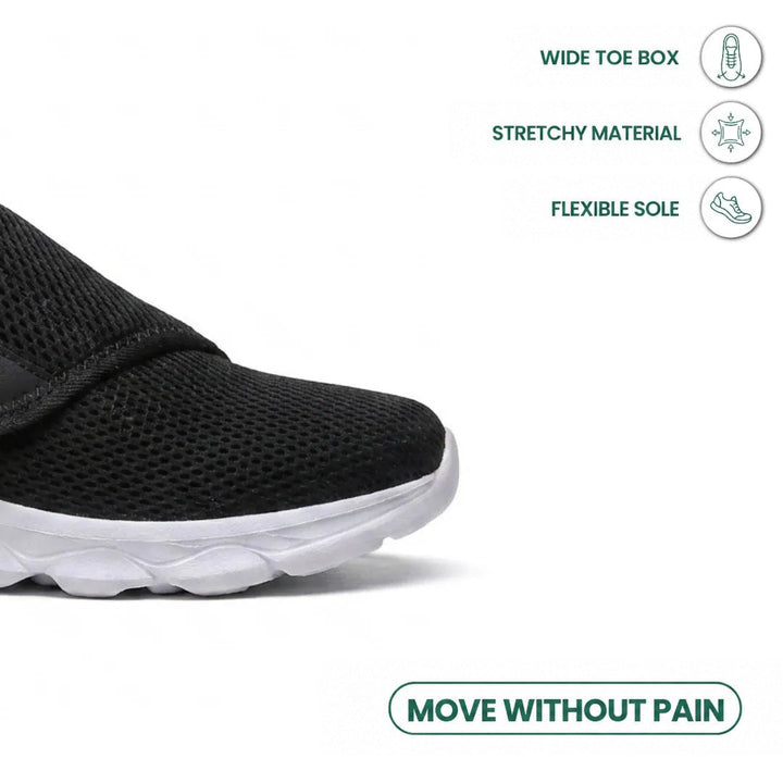 Close-up of the black mesh toe box and strap, with icons for roomy toe, stretch material and flexible sole 23