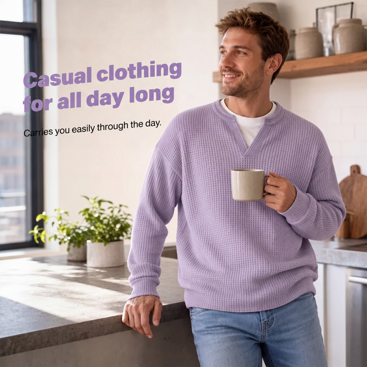 Smiling model in the lavender waffle knit top holding a mug while leaning on a kitchen counter 5