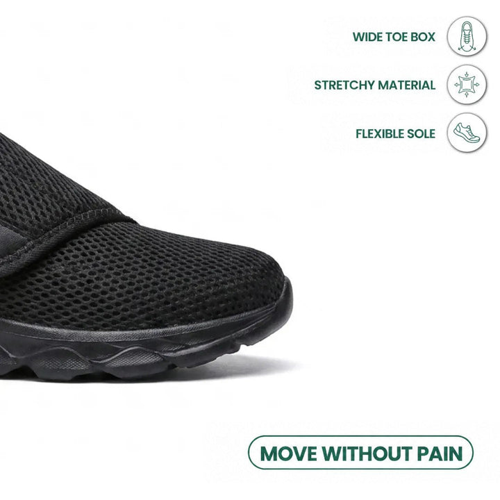 Close-up of the black shoe's wide toe box with icons about a roomy toe, stretch material and flexible sole 14