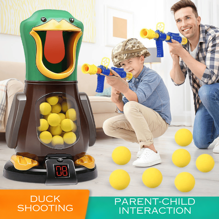 A father and son kneel in a living room aiming launchers at the green duck target 2