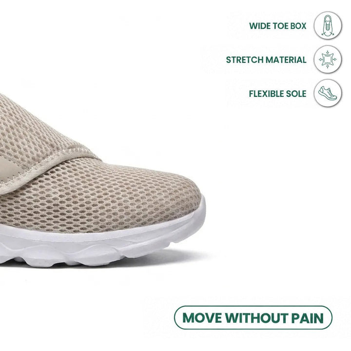 Close-up of the beige mesh toe box and strap, with icons for roomy toe, stretch material and flexible sole 32