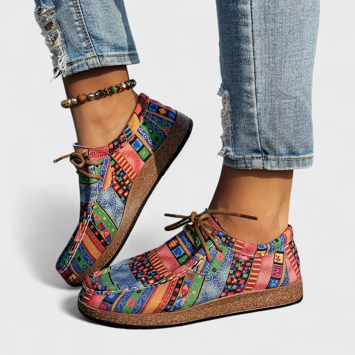 Pair of multicolored geometric-print lace-up sneakers in blue, green, pink and orange with brown soles.