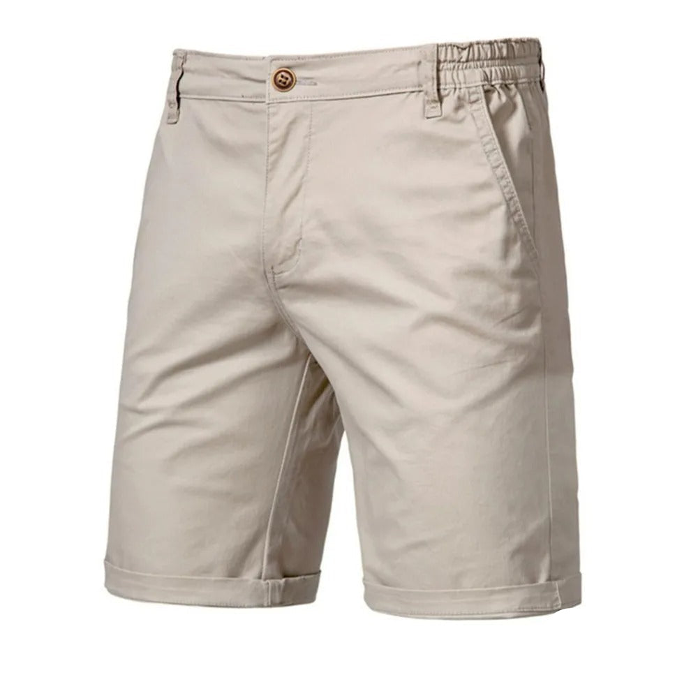 Front view of beige shorts with a brown button, slanted side pockets and rolled cuffs 1