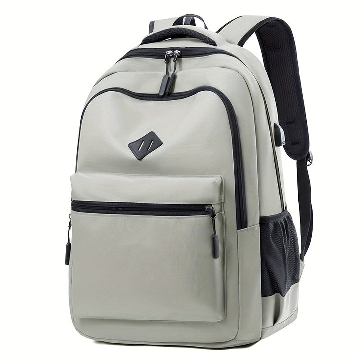 Black backpack with a large front pocket, mesh side pocket and padded shoulder straps, shown at an angle.
