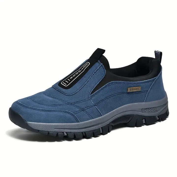 Side view of the same slip-on shoe in blue suede-look material with black collar, pull tab and a thick gray treaded sole. 2