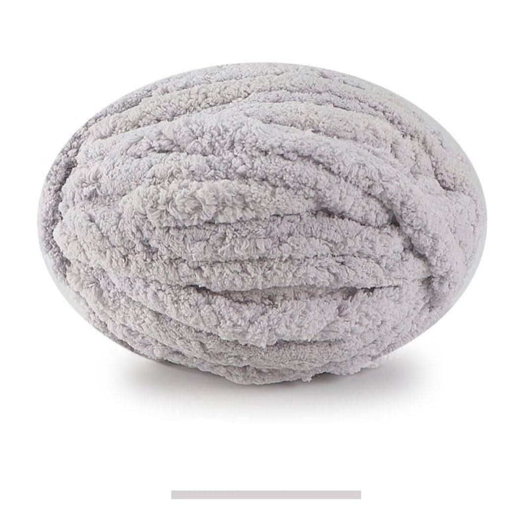 Single oval skein of light gray chunky yarn on a white background, with a color swatch bar below.