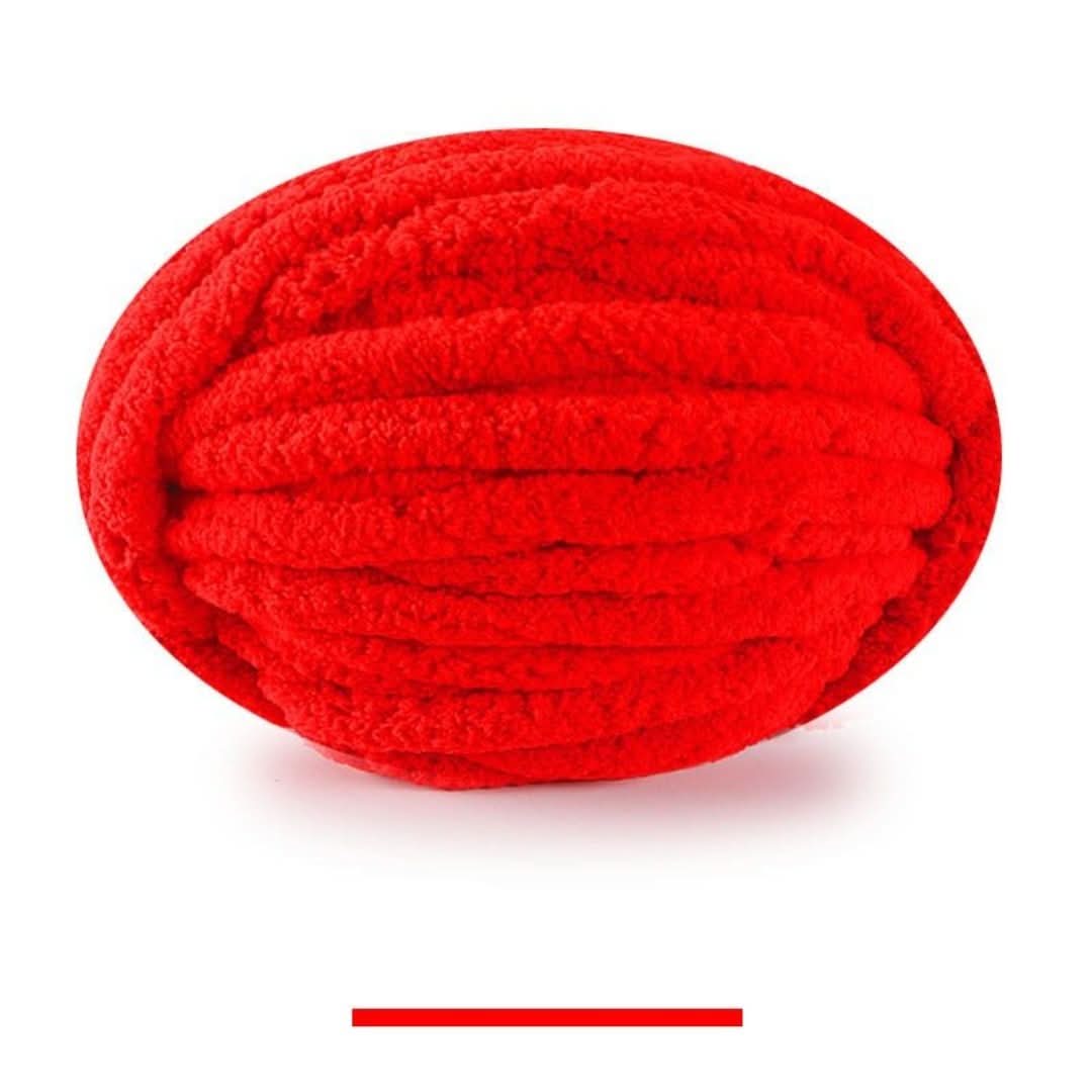 Single oval skein of bright red chunky yarn on a white background, with a color swatch bar below.