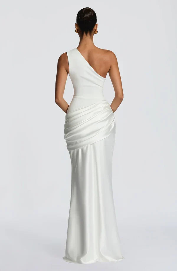 Sidonie One-Shoulder Draped Satin Maxi Dress in white, back view with the diagonal back neckline and gathered hip panel.