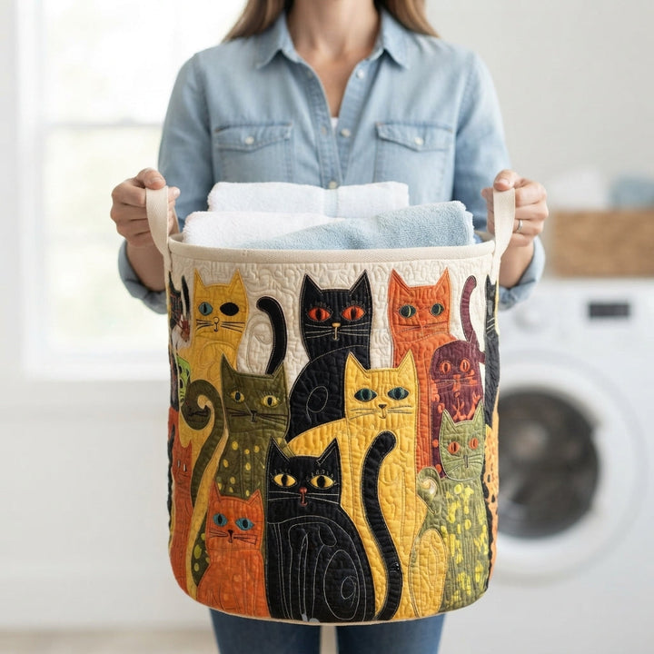 Another view of the quilted cat folk art laundry basket with cream handles and folded towels.