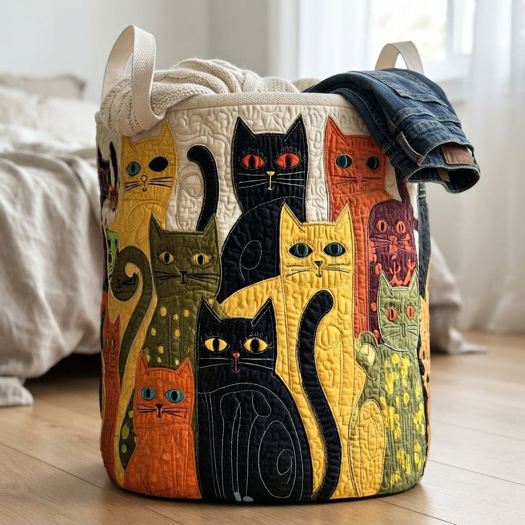 Another view of the quilted cat folk art laundry basket on a wood floor with a knit blanket and jeans.