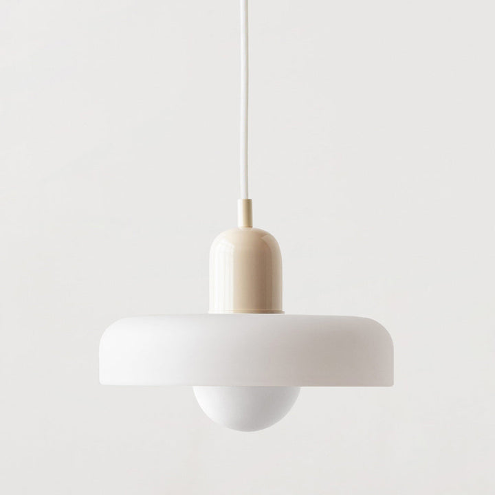 Matte white disc pendant lamp with a cream cap and white cord, seen straight on 46