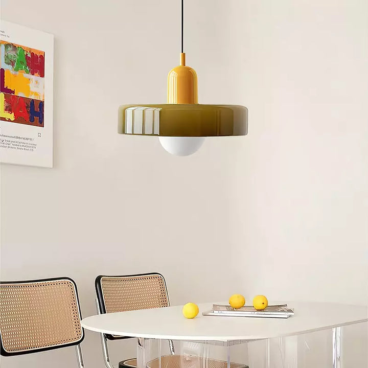 Olive pendant with a yellow cap hangs over a white oval table with lemons and cane chairs 18