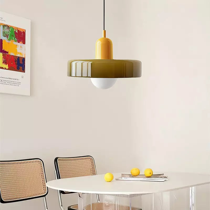 Olive pendant with yellow cap above a white oval table with lemons and cane-back chairs 18