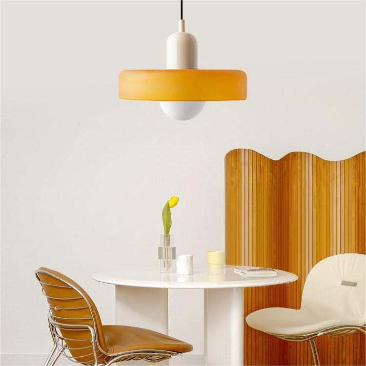 Amber shade with a cream cap hangs over a round white table, chairs and a tulip 29