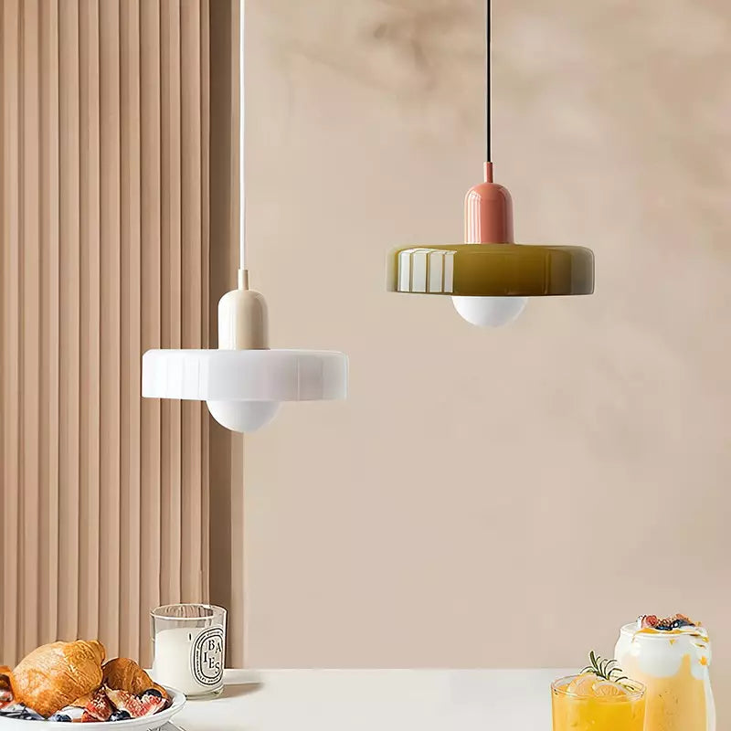 Two disc pendant lamps hanging above a breakfast table with pastries and drinks, one white and one olive 45