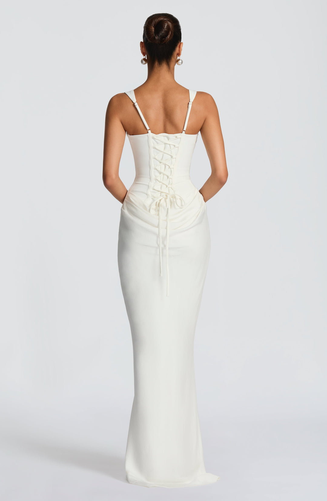Indy Bodycon Maxi Dress in cream white, back view with a lace-up closure and gathered hip drape.