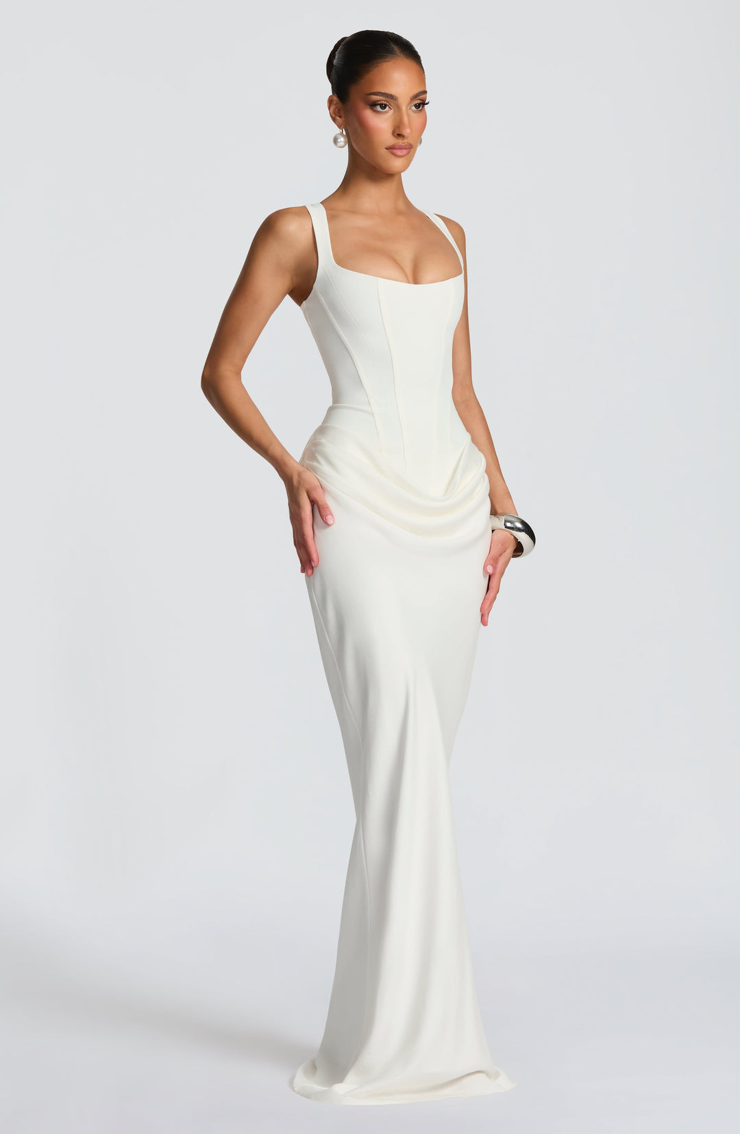 Indy Bodycon Maxi Dress in cream white, three-quarter view with a corset bodice and scoop neckline.