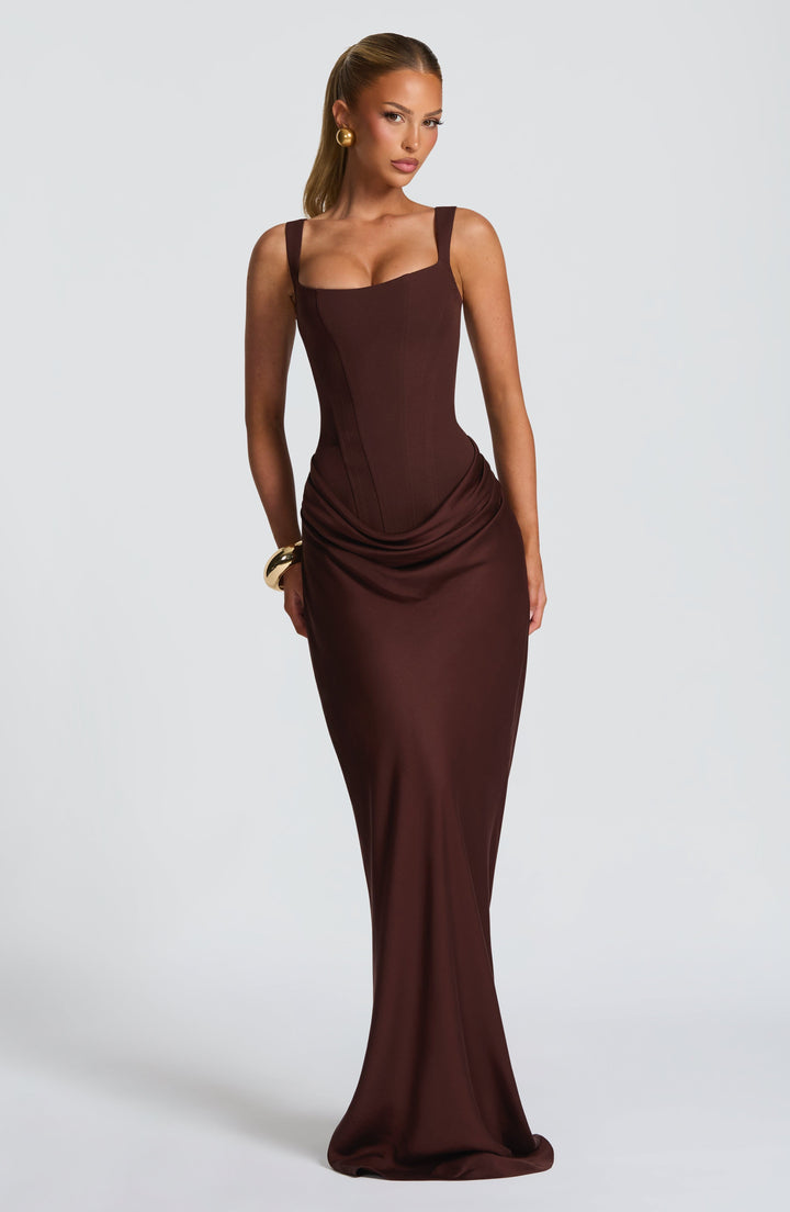 Indy Bodycon Maxi Dress in brown with wide straps and a draped hip detail, front view.