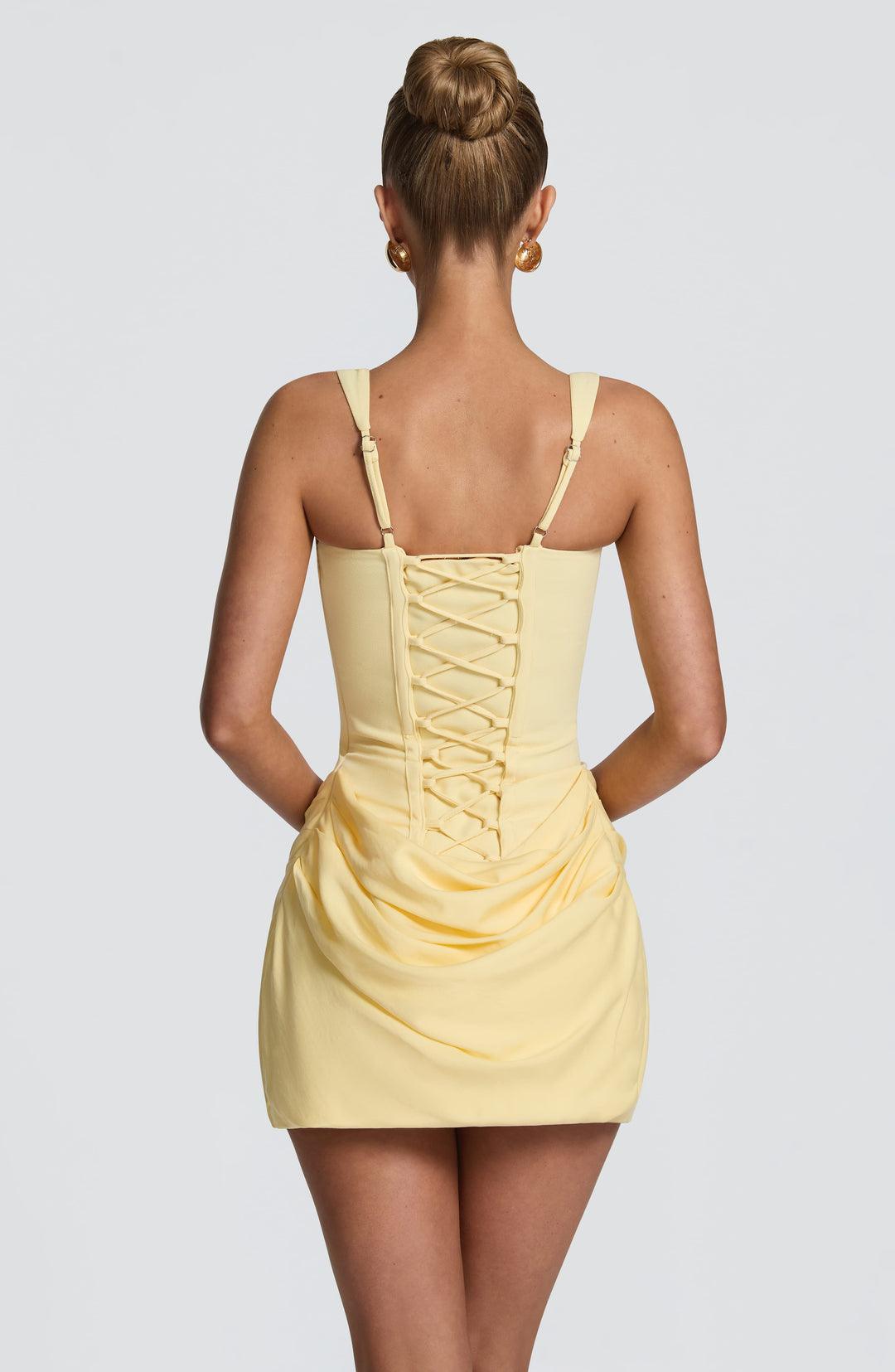 Back view of the pale yellow dress showing lace-up corset back and adjustable straps 23