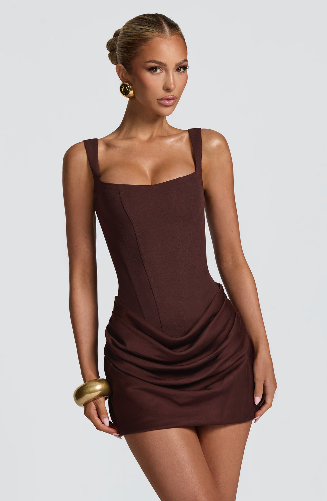 Indy Bodycon Mini Dress in brown, detail of the corset seams and draped skirt.