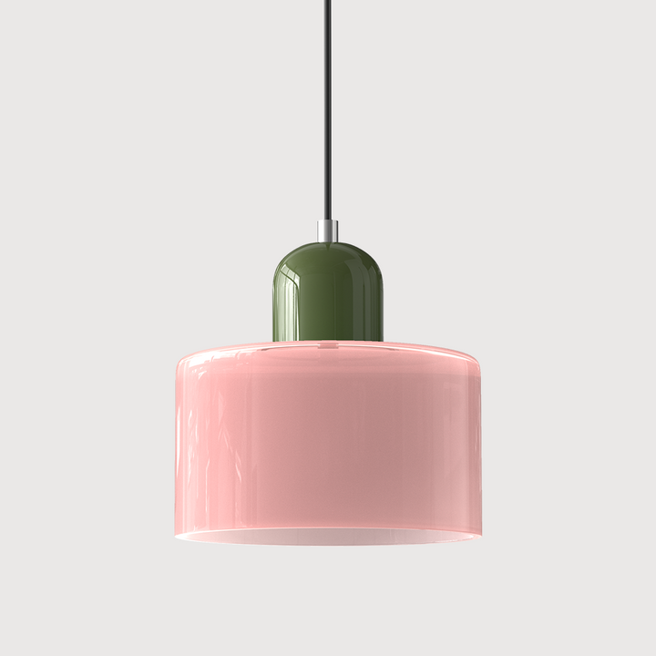 Pink glass drum pendant light with a green cap and black cord on a plain light background. 7