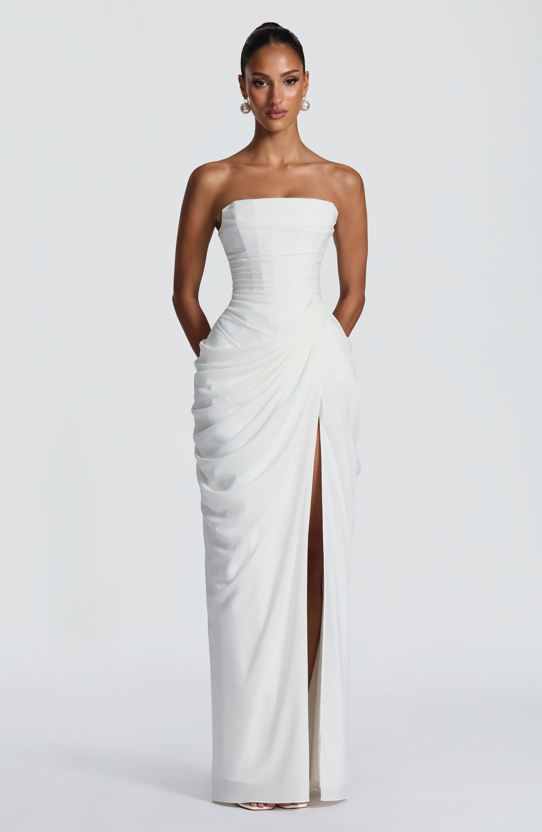 Lois Strapless Corset Maxi Dress with High Slit in white, front view with pockets