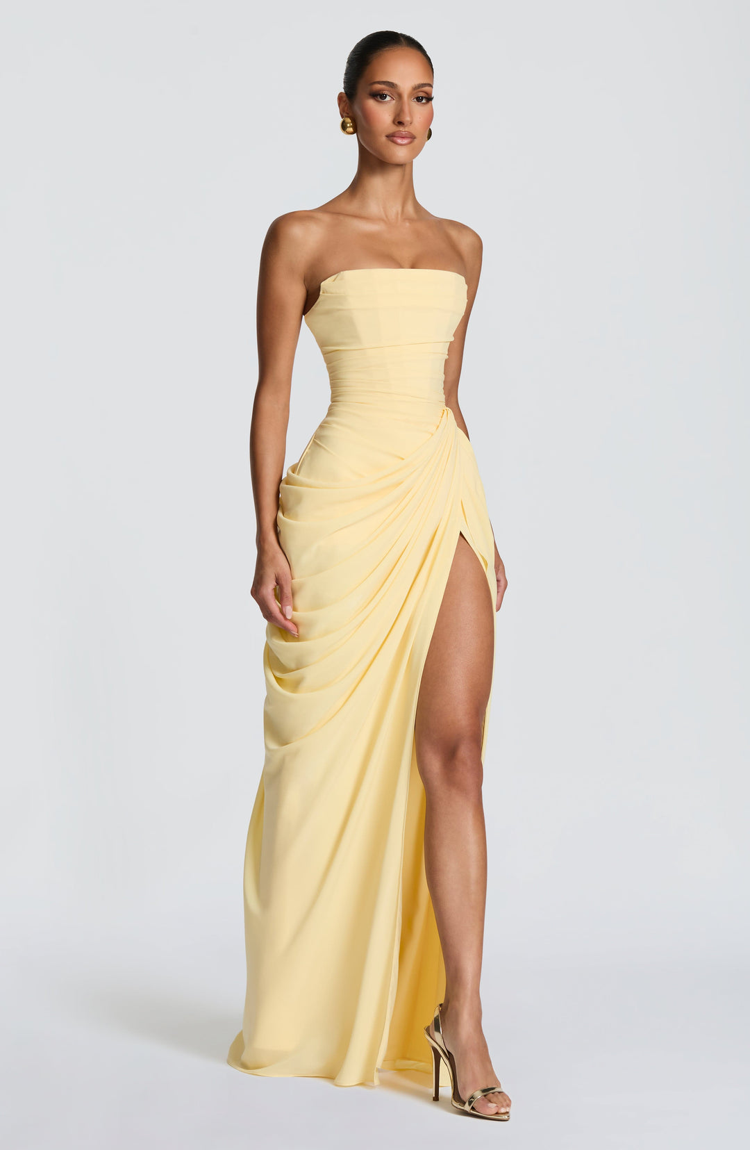 Lois Strapless Corset Maxi Dress with High Slit in pale yellow, three-quarter front view