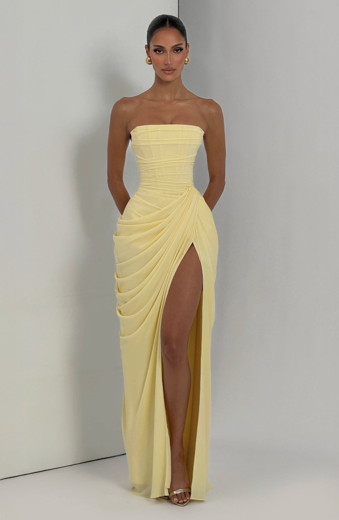Lois Strapless Corset Maxi Dress with High Slit in pale yellow, front view