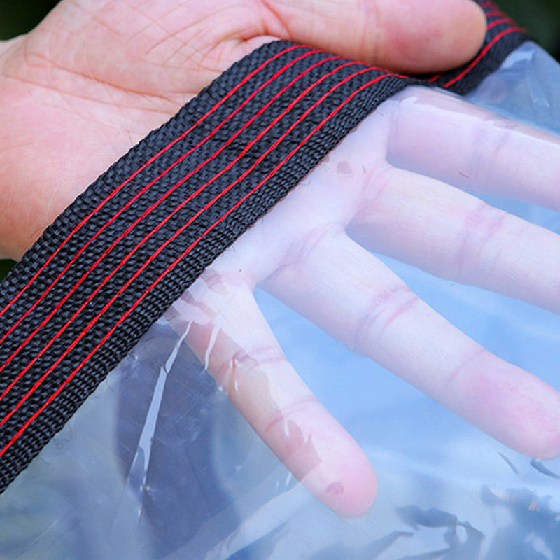 Close-up of a hand pressed against the transparent sheet with a black woven border.