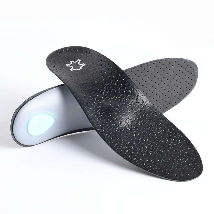 Pair of black perforated insoles crossed on a white background, one showing its top surface and the other its underside with a clear arch shell and blue heel pa