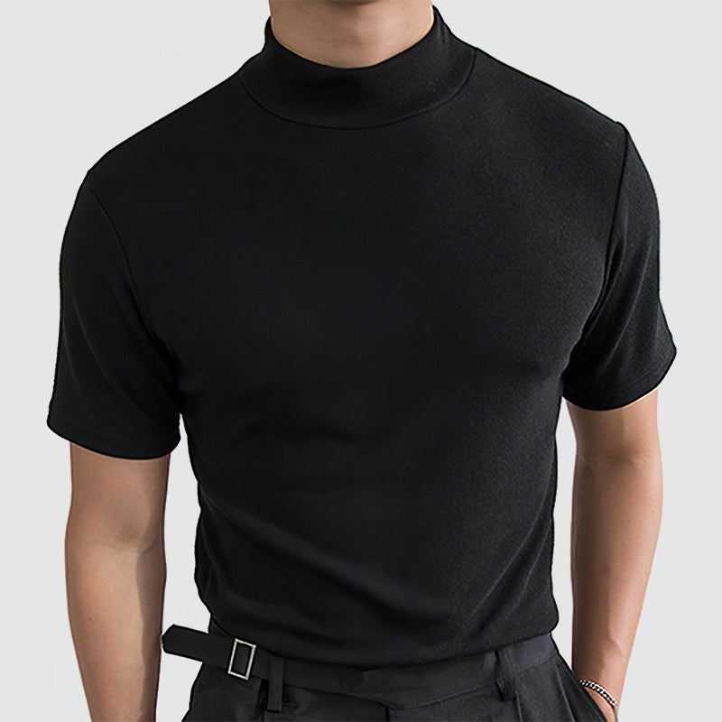 Close front view of the black mock-neck tee on a model, showing the fitted shoulders and snug sleeves.