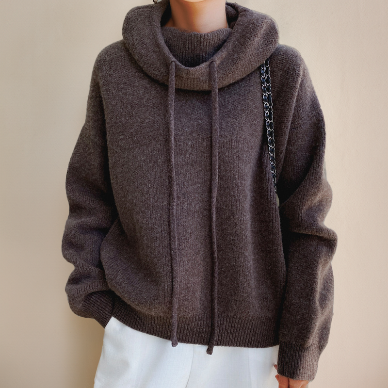 Front view of a brown relaxed-fit knit sweater with a folded cowl neck and two long drawstrings 7