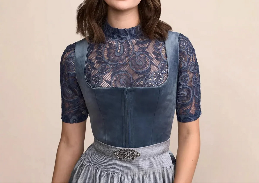 Dirndl dress detail showing the blue lace neckline and sleeves, front zipper and metal brooch on the waistband