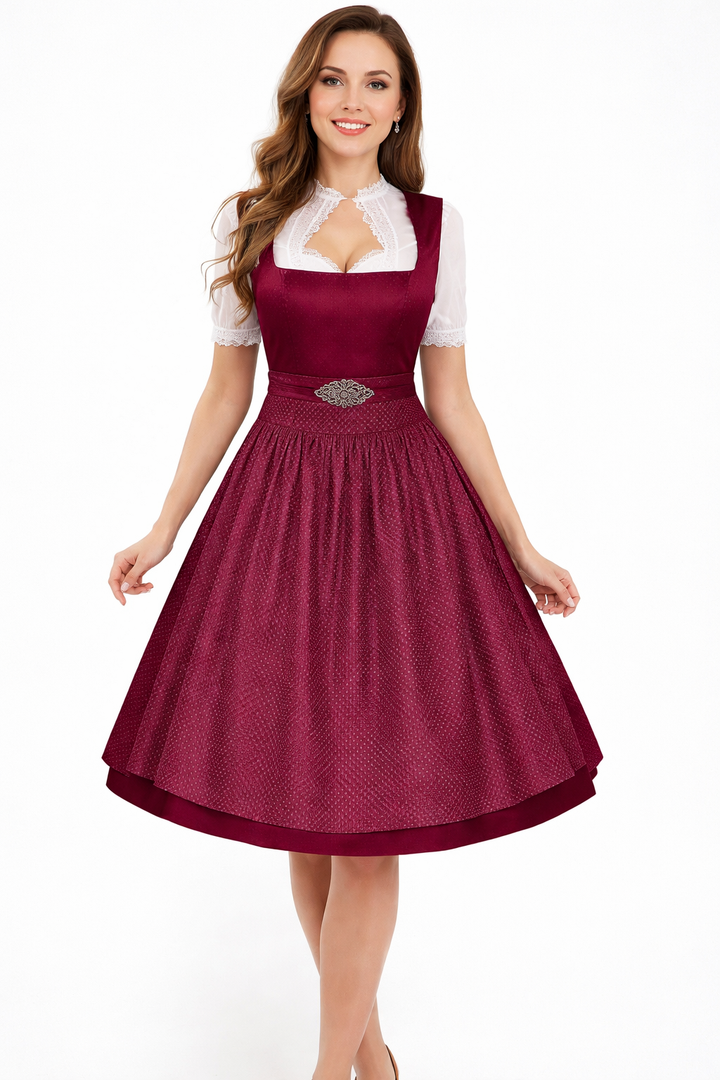 Model in a burgundy dirndl with a dotted textured apron, ornate waist clasp and white lace-trimmed blouse with keyhole collar. 4