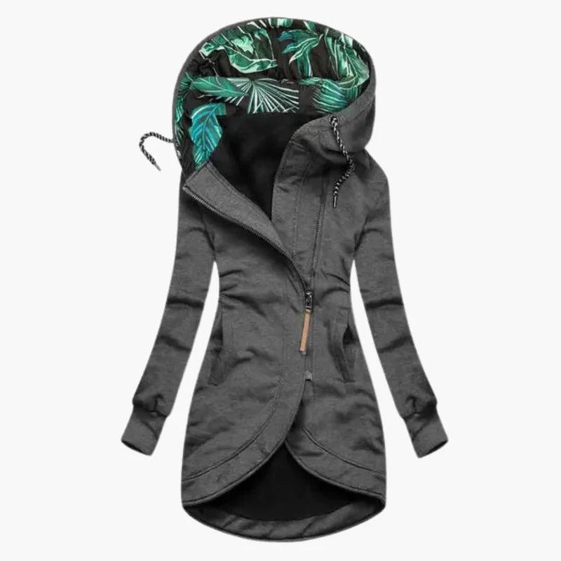 Dark gray version of the jacket, front view, showing the green leaf-print hood lining, slanted zipper with leather pull and rounded hem.
