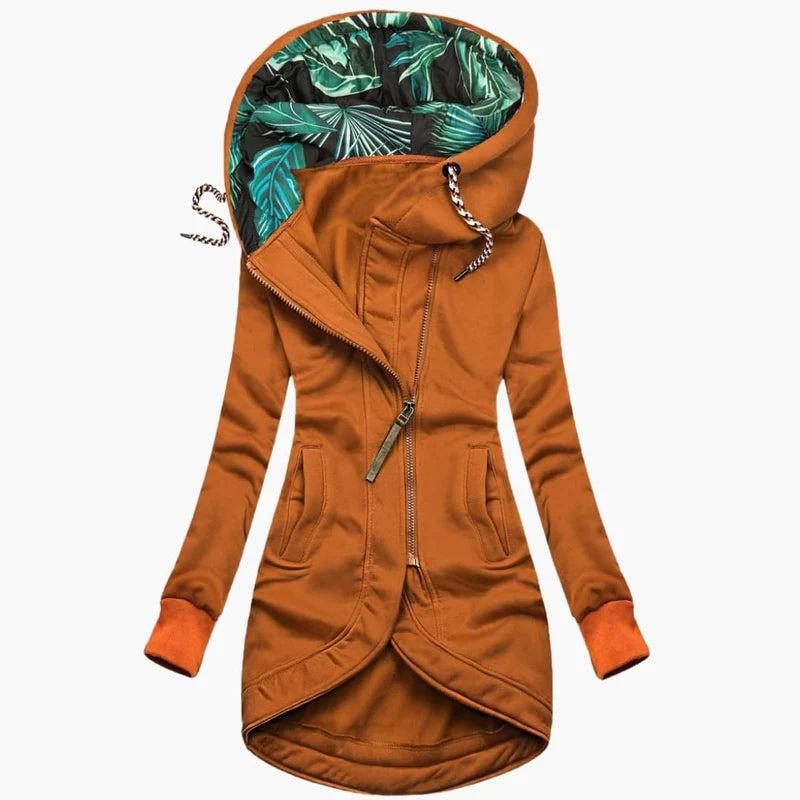 Rust orange version of the jacket, front view, with leaf-print hood lining, metal zipper pull, side pockets and matching ribbed cuffs.
