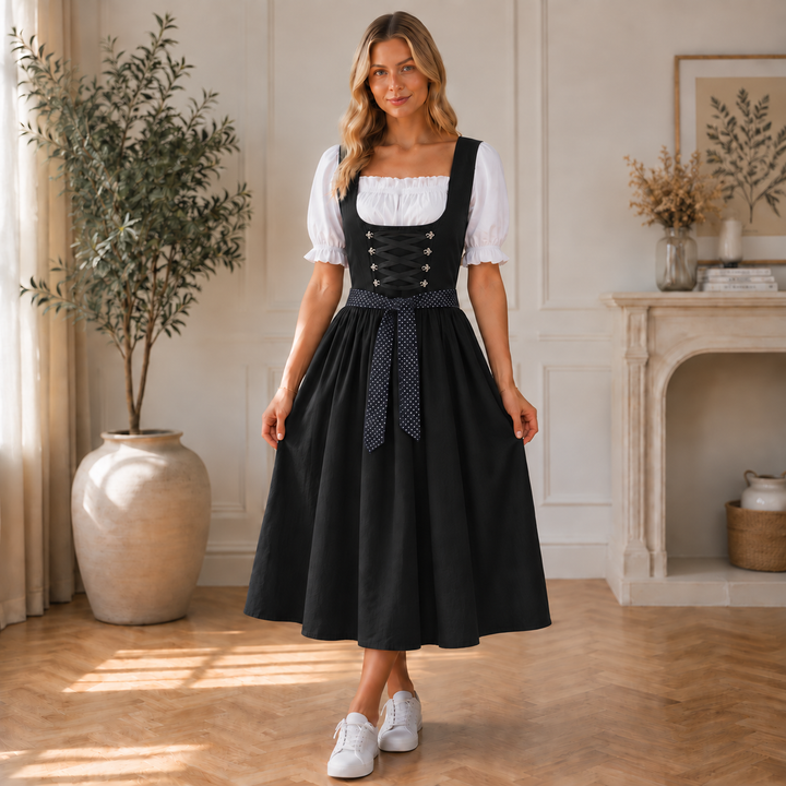 Black midi dirndl dress detail with lace-up bodice and polka-dot sash