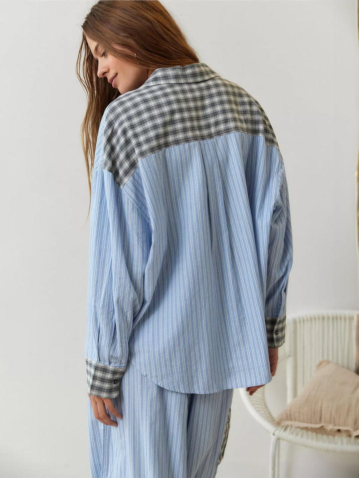 Blue striped pajama shirt showing the gray plaid yoke and cuffs, back view.