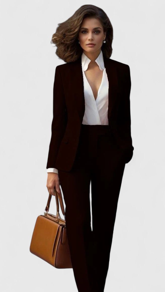 Model in the suit in black with a white blouse, holding a tan leather handbag 7