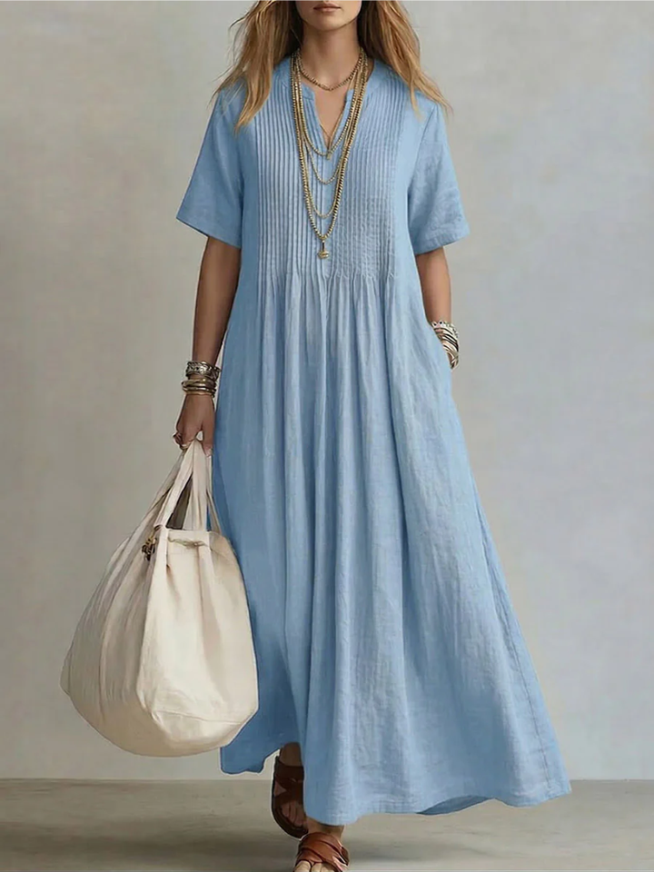 Model wears the short-sleeve pleated dress in light sky blue, detail.