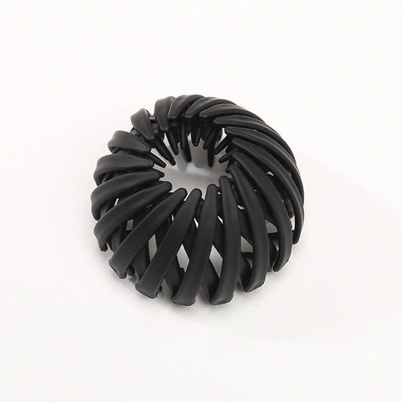 Twist-and-snap hair clip in black velvet shown from above.
