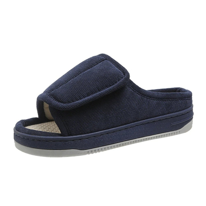 Navy blue corduroy slipper detail on a white background with a wide adjustable strap and open toe.