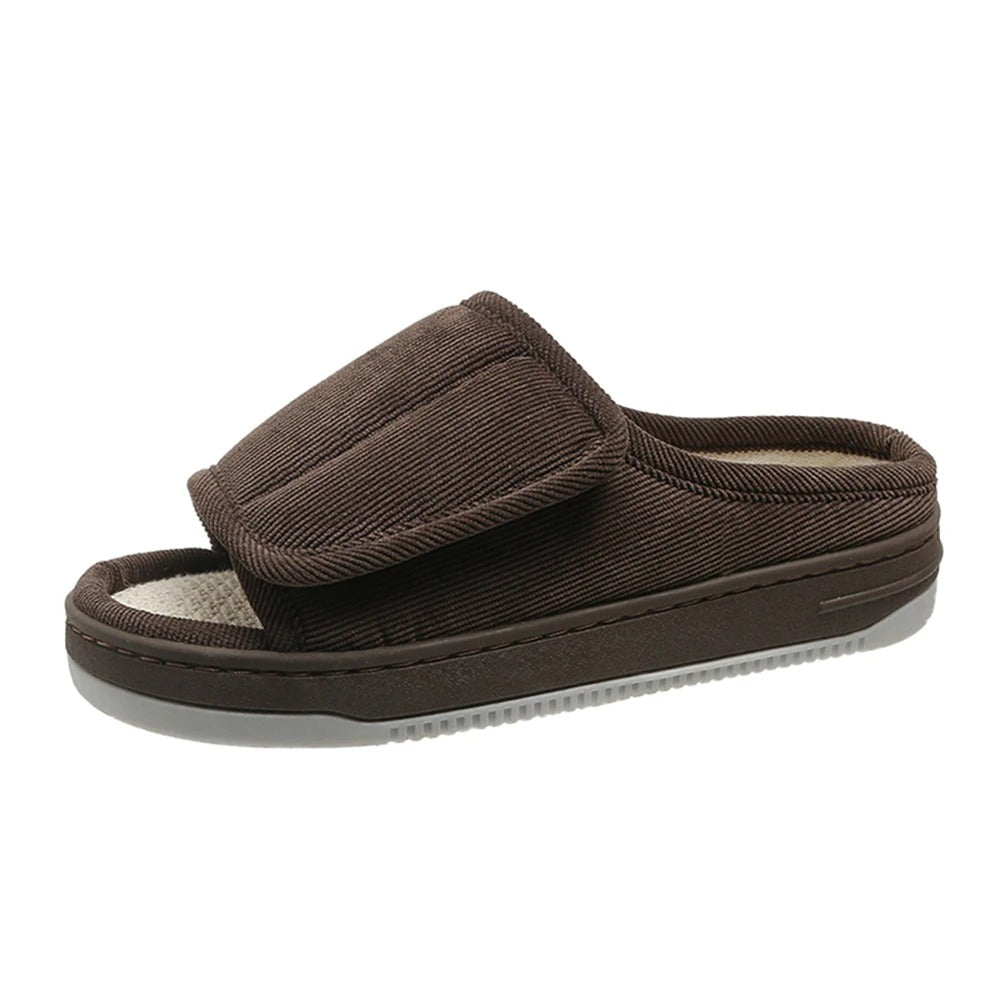Brown corduroy open-toe slipper with a wide adjustable strap, woven beige footbed and gray ridged sole, shown from the side. 5