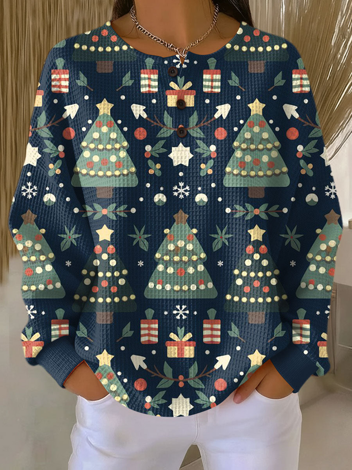 Navy waffle knit henley printed with green Christmas trees, gift boxes and snowflakes, worn by a model 8