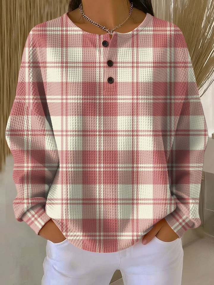 Waffle knit henley in pink and cream plaid with three buttons at the neckline, worn by a model 15
