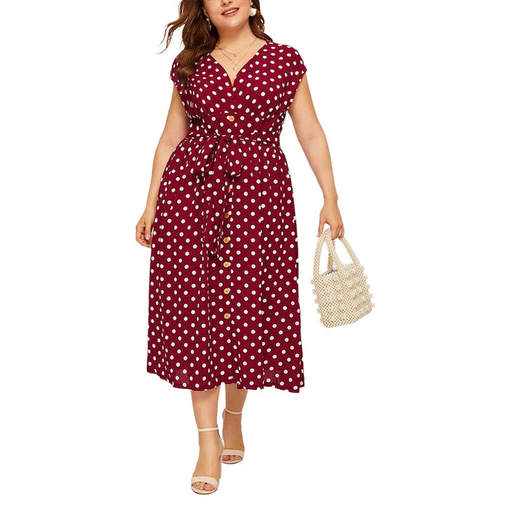 Frau im roten gepunkteten Kleid mit Gürtel, hält weiße Perlenhandtasche, Sommermode.